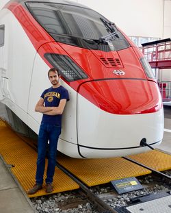 Andrew in front of a Swiss high-speed train locomotive